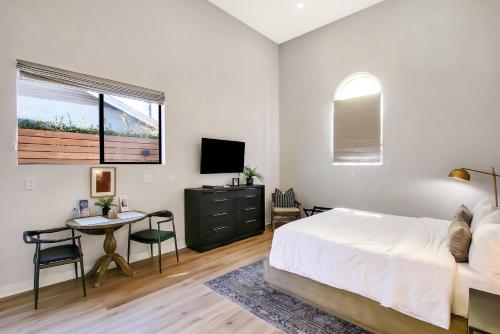 a bedroom with a bed and a desk and a tv at Villa Castillo 3 in Santa Barbara
