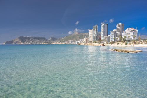 a large body of water with a beach and buildings at Coco Calpe in Calpe