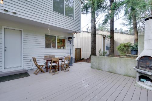 a patio with a table and chairs next to a house at Lake Oswego Home with Deck 9 Mi to Downtown Portland in Lake Oswego