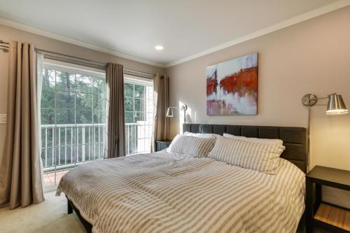 a bedroom with a bed and a large window at Lake Oswego Home with Deck 9 Mi to Downtown Portland in Lake Oswego