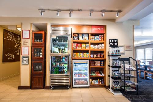 a store with a refrigerator and shelves of food at TownePlace Suites by Marriott Gilford in Gilford