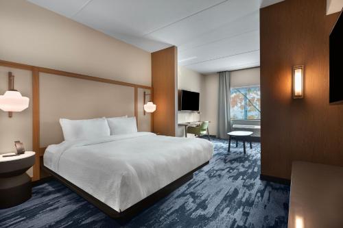 a hotel room with a bed and a desk at Fairfield by Marriott Inn & Suites Coastal Carolina Conway in Conway