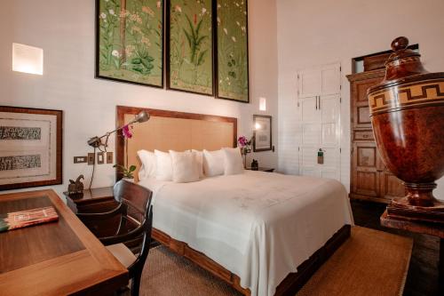 a hotel room with a bed and a table and a desk at Amarla Boutique Hotel Cartagena in Cartagena de Indias