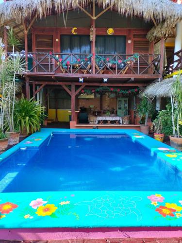 a swimming pool in front of a resort at Villas La Bella Margarita in Brisas de Zicatela