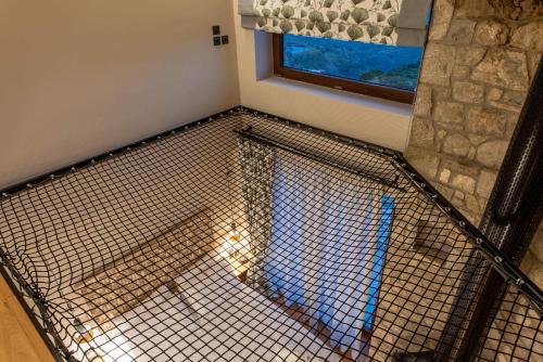 a cage in a room with a window at 5 Raches Suites in Arachova