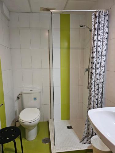 a bathroom with a toilet and a sink at Apartamentos La Mar in Altea