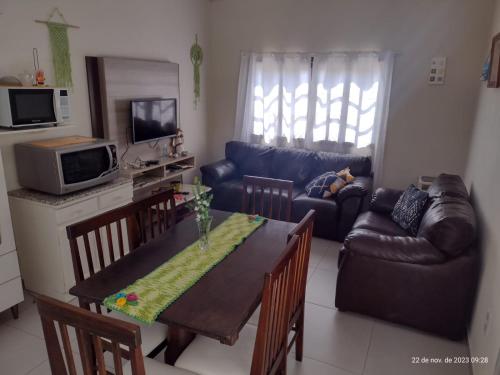 a living room with a table and a couch at APARTAMENTO MARISCAL in Bombinhas