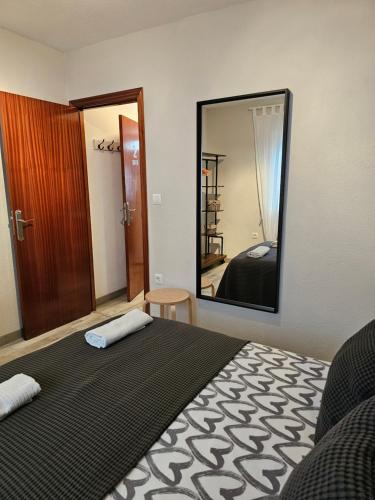 a bedroom with a bed and a large mirror at Apartamentos La Mar in Altea