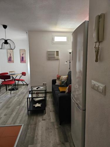 a living room with a couch and a table at Apartamentos La Mar in Altea