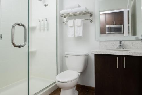a bathroom with a toilet and a sink and a shower at TownePlace Suites by Marriott Olympia in Olympia