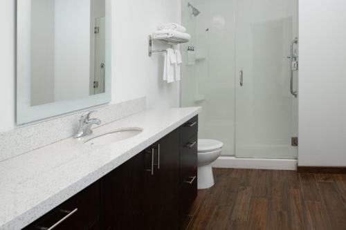 a bathroom with a sink and a toilet and a mirror at TownePlace Suites by Marriott Olympia in Olympia