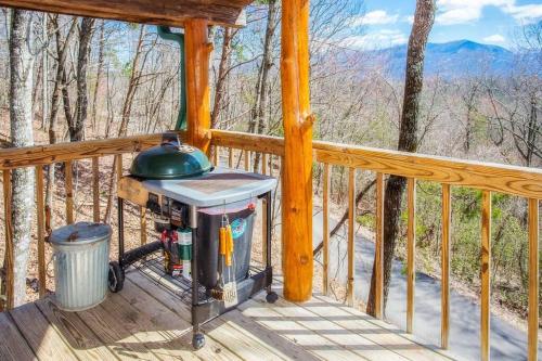 a gas grill on a deck on a cabin at The Pine Knot Cabin in Sevierville