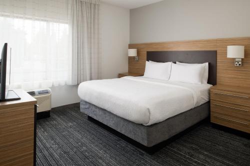 a hotel room with a bed and a television at TownePlace Suites by Marriott Olympia in Olympia