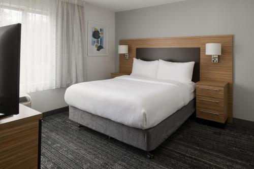 a hotel room with a large bed and a television at TownePlace Suites by Marriott Olympia in Olympia