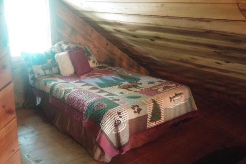 a bedroom with a bed in a log cabin at The Pine Knot Cabin in Sevierville