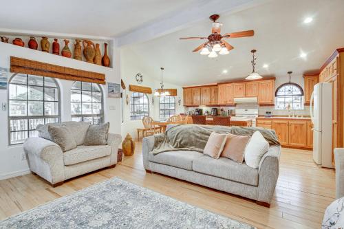 a living room with two couches and a kitchen at Canalfront Port Isabel Cottage 5 Mi to Beach! in Port Isabel