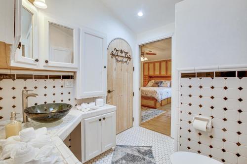 a bathroom with a sink and a room with a bed at Canalfront Port Isabel Cottage 5 Mi to Beach! in Port Isabel
