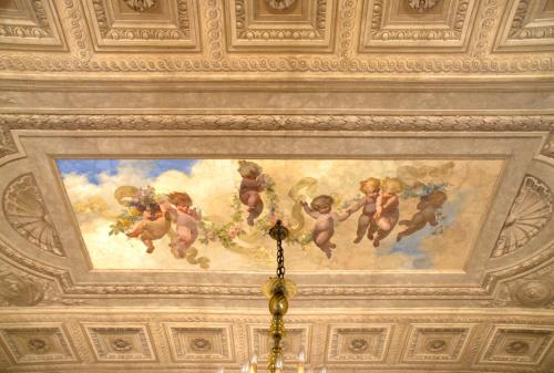 a painting on the ceiling of a room at Boutique Hotel Atelier '800 in Rome