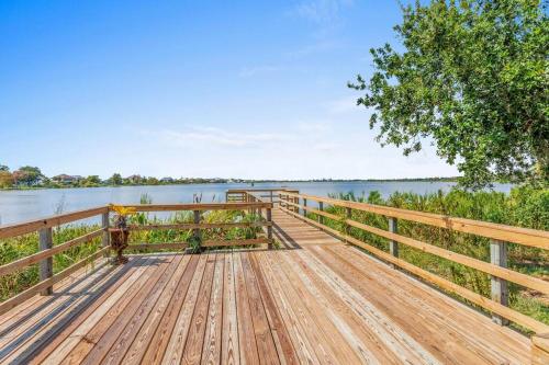 a wooden dock with a view of a lake at Waterfront 4 Bedroom Home in Lake Charles