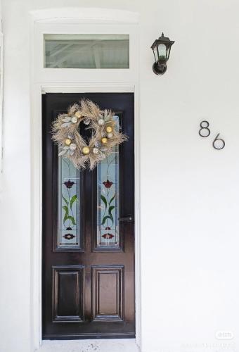 a front door with a wreath on it at Stylish Queen Room 1Min Walk to Station 5Min to City 10Min to Airport in Sydney