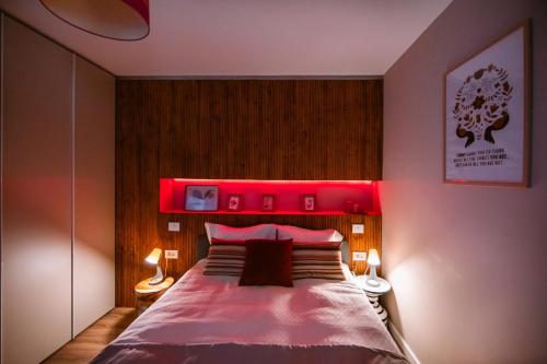 a bedroom with a large bed with a red headboard at Hello Adventure in Sinaia