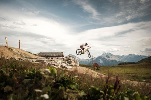 a man doing a trick on a bike in the air at Chalet Sonnenröschen in Blatten bei Naters