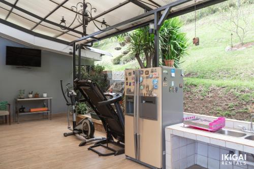 a kitchen with a refrigerator and a treadmill at Casa Rinu in San José
