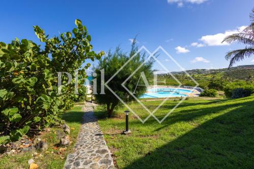 an image of a garden with a swimming pool at Suite Résidence Mont Vernon in Orient Bay French St Martin