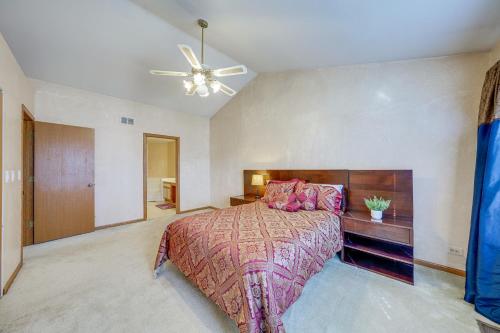 a bedroom with a bed and a ceiling fan at Hanover Park Townhome with Grill 36 Mi to Chicago! in Hanover Park