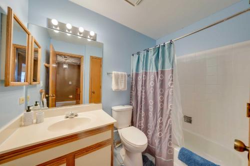 a bathroom with a toilet and a sink and a shower at Hanover Park Townhome with Grill 36 Mi to Chicago! in Hanover Park