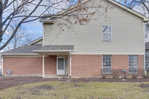 a white house with a brick at Hanover Park Townhome with Grill 36 Mi to Chicago! in Hanover Park