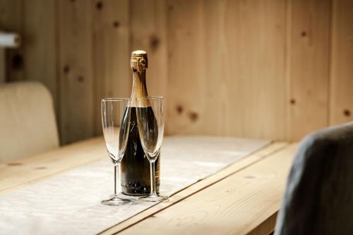 a bottle of champagne sitting on a table with a glass at Apartmán Bruno so saunou in Demanovska Dolina