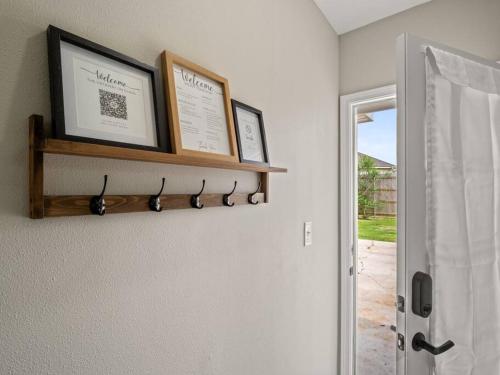 a room with a shelf with two pictures on the wall at Beautiful 3 Bedroom Home in Lake Charles