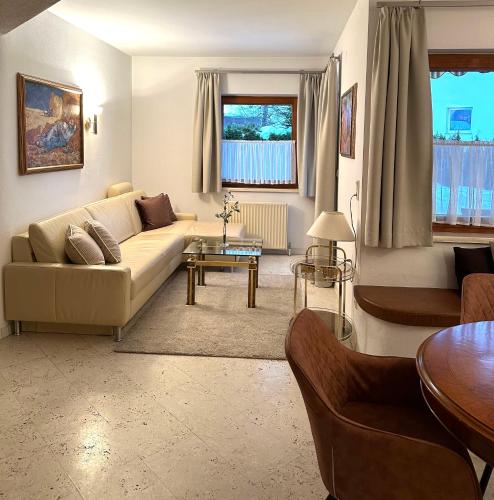 a living room with a couch and a table at Landhaus Solaris in Leutasch
