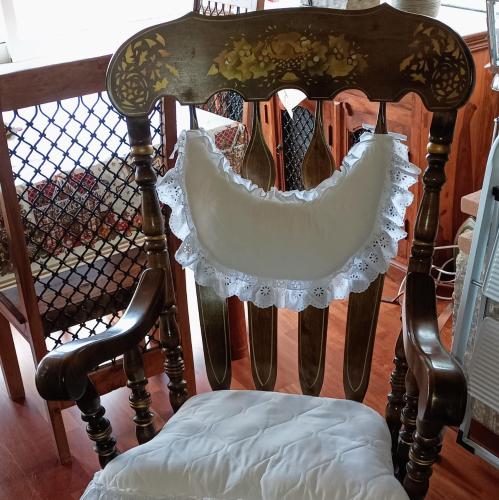 a wooden chair with a white pillow on it at Η θέα Τhe View in Lílaia
