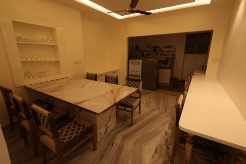 a kitchen and dining room with a table and chairs at Shuddhi Villa by Aarogya's in Udaipur