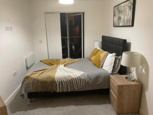 a bedroom with a bed and a lamp in it at City centre apartment in Manchester