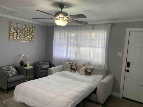 a bedroom with a bed and a ceiling fan at Home in Hempstead in Hempstead