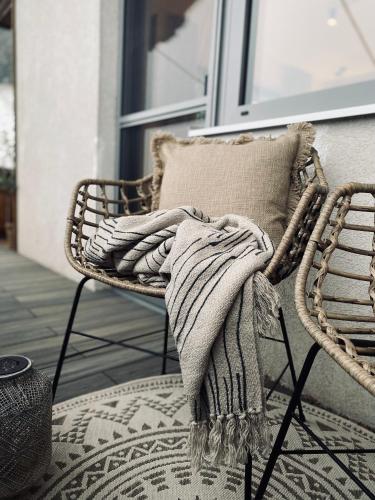 a blanket sitting on a chair on a porch at Apartments Riese in Neustift im Stubaital
