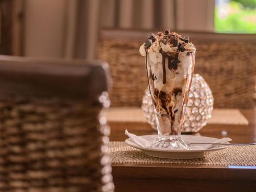 a dessert in a glass on a plate on a table at Monkey Thorn Lodge & Wellness Spa - Adults Only in White River