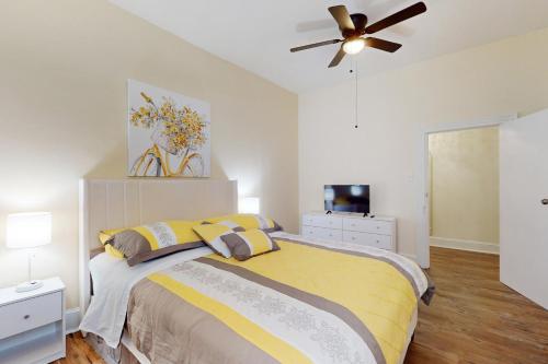 a bedroom with a bed and a ceiling fan at Market Street Memories in Frederick