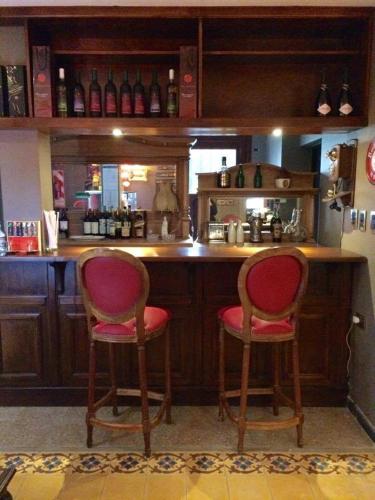 two chairs sitting at a bar in a kitchen at Hotel City Bell in La Plata
