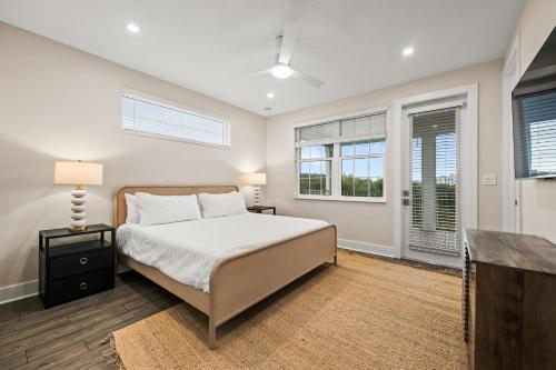 a bedroom with a bed and two windows at Salty Seagull at Hunter's Point in Cortez