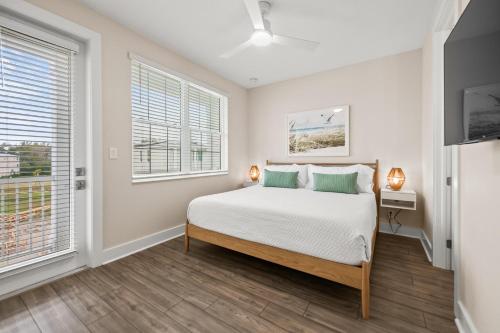 a bedroom with a bed and two windows at Salty Seagull at Hunter's Point in Cortez