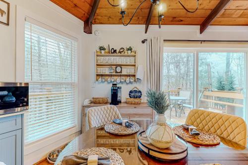 a kitchen with a table and chairs and a dining room at The Beech Hut in Beech Mountain