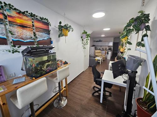 an office with a fish tank on a desk at Casa De Moises in Tel Aviv