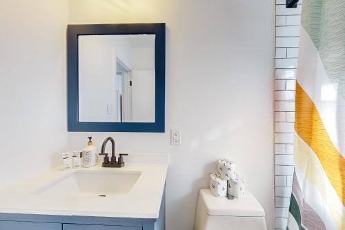 a bathroom with a sink and a mirror at The Desert Brickstone in Phoenix