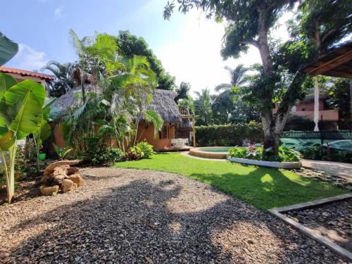 a house with a yard with a grassy yard at El Manguito in Sayulita