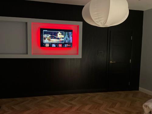 a room with a red painting on a black wall at Luxury Home in Blackpool in Blackpool