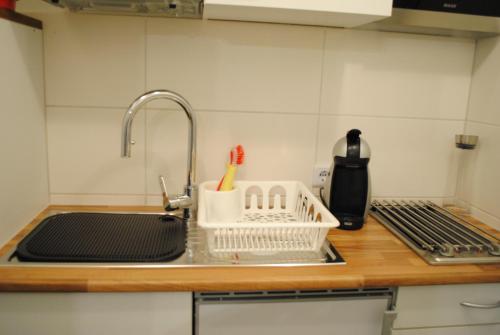 a kitchen counter top with a sink and a sink at Appartement Matthias in Vörstetten